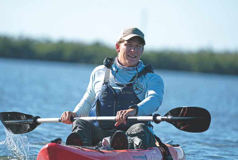 a man rowing a boat in a body of water